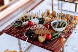 vlees en kaas snacks Aan de buffet tafel. open lucht buffet tafel, boterhammen Aan spiesjes voordat de begin van de vakantie. foto