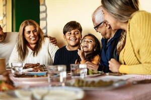 gelukkig Latijns familie hebben pret lunchen samen Bij huis foto