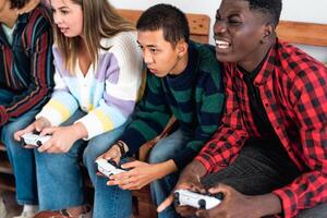jong multiraciaal tieners spelen online video spel troosten Bij huis - jeugd mensen verslaafd naar nieuw technologie gaming vermaak foto