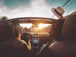 gelukkig meisjes aan het doen weg reis in tropisch stad - reizen mensen hebben pret het rijden in modieus converteerbaar auto ontdekken nieuw plaatsen - vriendschap en jeugd vriendinnetjes vakantie levensstijl concept foto