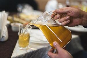 gieten een vers drinken van een karaf in een glas foto