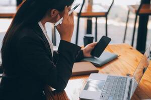 Aziatisch Dames zijn benadrukt terwijl werken Aan laptop, moe Aziatisch zakenvrouw met hoofdpijn Bij kantoor, gevoel ziek Bij werk, kopiëren ruimte foto