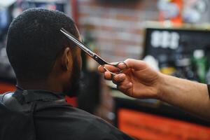 bezoekende kapperszaak. Afrikaanse Amerikaans Mens in een elegant kapper winkel foto