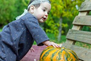 de weinig kind spelen in de park met fruit, weinig meisje in de herfst park foto