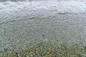 water druppels Aan de strand, dichtbij omhoog van een zand Aan de strand foto