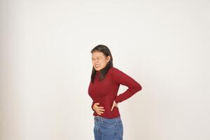 jong Aziatisch vrouw in rood t-shirt lijden maagpijn, pijn Aan maag geïsoleerd Aan wit achtergrond foto