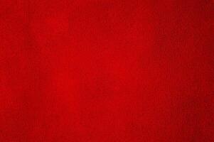 structuur van natuurlijk rood suède. achtergrond van een rood perfect suede kleding stof. fluweel textuur. foto