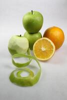 een stapel van groen appel fruit en oranje fruit geïsoleerd Aan wit achtergrond foto