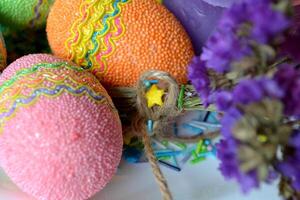 kleurrijk Pasen eieren met bloemen in de bord. mooi Pasen achtergrond. Pasen kaart. eigengemaakt vakantie decor. foto