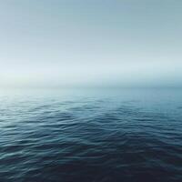 ai gegenereerd de sereen uitgestrektheid van een kalmte oceaan mengsels in een nevelig horizon in nevelig ochtend- licht foto
