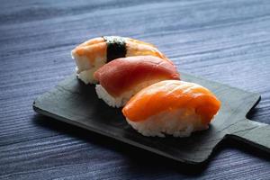 drie verschillende nigiri's. zalm, tonijn en garnalen foto
