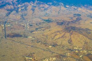 vliegend vliegtuig over- Mexico wolken lucht vulkanen bergen stad woestijn. foto