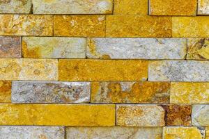 geel oranje bakstenen van een muur structuur patroon Mexico. foto