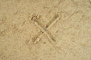 zand met X teken achtergrond foto