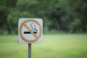 Nee roken teken in de openbaar tuin. etiket Nee roken metaal teken in de park foto