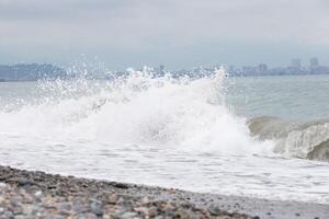 mooi bries van de golven van de zee tegen de backdrop van de stad. foto