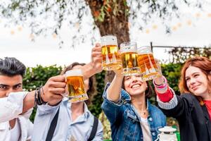 groep van vrienden hebben pret Bij tuin huis partij - jong mensen glimlachen samen drinken bier foto