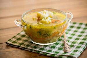 gekookt kip soep met bloemkool en groenten in een kom foto