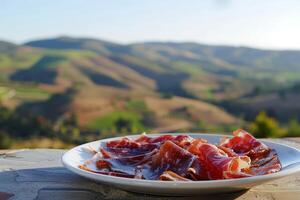 ai gegenereerd bord van Jamon Iberico met de rollend heuvels van Andalusië in zacht zonsondergang licht - authentiek Spaans lekkernij foto