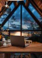een laptop Aan een houten bureau in een modern knus cabine huis leven kamer in de avond met een zonsondergang visie foto