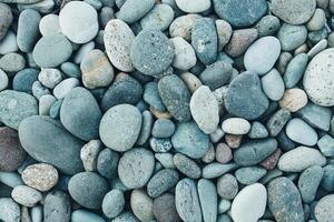 abstract achtergrond met droog ronde piemel stenen. zee steen dichtbij omhoog foto