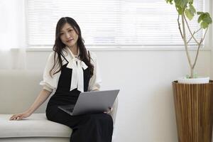 een Japans vrouw controle smartphone door afgelegen werk in de huis kantoor foto