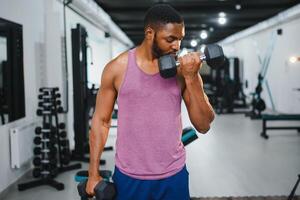 portret Afrikaanse Amerikaans bodybuilder Bij Sportschool intens intimiderend schittering uitdrukking overtuiging. foto