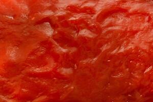 levendig dichtbij omhoog, tomaat saus en ketchup structuur achtergrond. foto