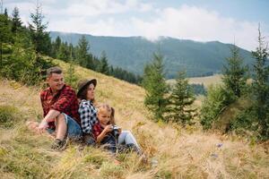 jong familie met kind resting Aan een berg. foto