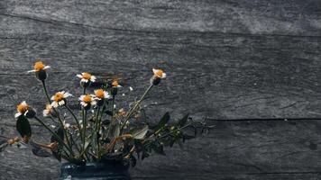 wild bloemen in de keramisch vaas in de houten tafel foto