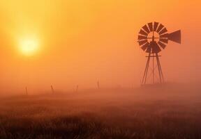 ai gegenereerd windmolen in de de nevel Bij zonsopkomst foto