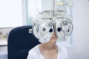 kind oog examen, kind oog testen, phoropter oog test foto
