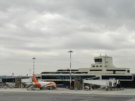 Milaan, Italië - 17 augustus 2023. passagier vlak met gedekt luchttrappen staat in voorkant van de luchthaven foto