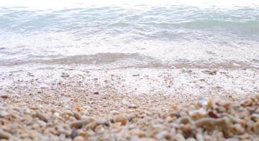 strand zand en zee Golf Aan wit achtergrond, zacht focus. foto