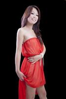 jong mager aantrekkelijk Aziatisch vrouw oranje jurk foto