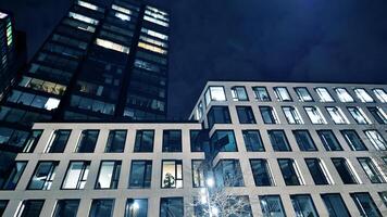 kantoor gebouwen door nacht. nacht architectonisch, gebouwen met glas facade. modern gebouwen in bedrijf wijk. concept van economie, financieel. foto