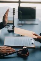 rechtvaardigheid en recht concept.male rechter in een rechtszaal met de hamer, werken met, computer en docking toetsenbord, brillen, op tafel in ochtendlicht foto