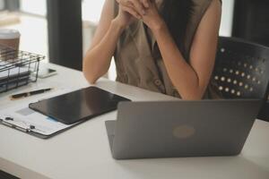 schot van een Aziatisch jong bedrijf vrouw werken Aan laptop in haar werkstation. foto