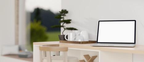 een wit scherm laptop computer mockup Aan een houten kabinet aanrecht in een modern wit kamer. foto