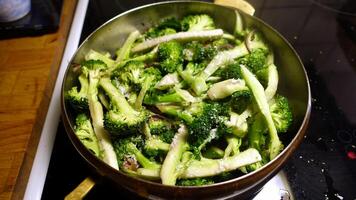broccoli besnoeiing en zetten in een pan met olie en ui foto