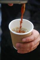 persoon Holding een kop van koffie in een caf foto