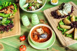 tafel weergeven geassorteerd borden van voedsel en kommen van salade foto