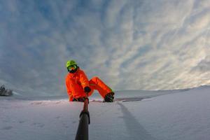 snowboarder met het snowboard die een selfie maakt foto