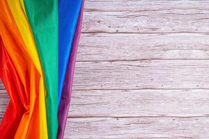 detailopname van lgbt vlag Aan houten tafel. ruimte voor tekst foto