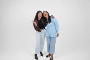twee jong Aziatisch Dames uitdrukken hun geluk, geïsoleerd door wit achtergrond. vriendschap concept. foto