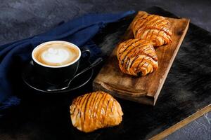 geserveerd Aan houten bord met kop van koffie latte kunst geïsoleerd Aan servet kant visie van Frans ontbijt gebakken voedsel item Aan grijs achtergrond foto