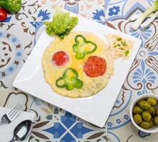 gebakken ei met kaas omvatten klok peper en tomaat geserveerd in schotel geïsoleerd Aan tafel top visie van Arabisch voedsel foto