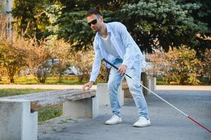 Blind Mens. visueel verminderd Mens met wandelen stok, foto