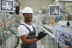 professioneel zwaar industrie ingenieur arbeider vervelend uniform, bril en moeilijk hoed in een fabriek foto