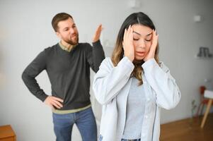 emotioneel Mens gebaren en geschreeuw Bij zijn vrouw, jong paar hebben ruzie Bij huis. huiselijk misbruik concept foto